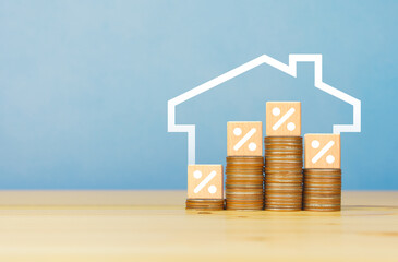 House icon on background with Percentage sign on wooden block. Refinance to reduce the interest of home loan. mortgage interest rate