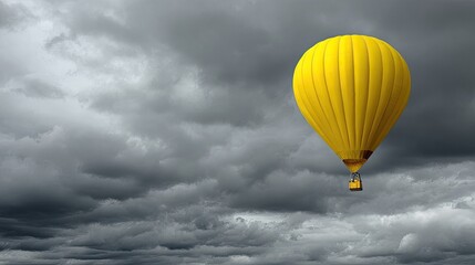 Yellow hot air balloon in stormy sky