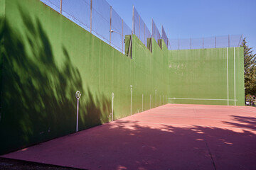 Fronton. A fronton court for playing pelota. It's located in the sports area of a small town.