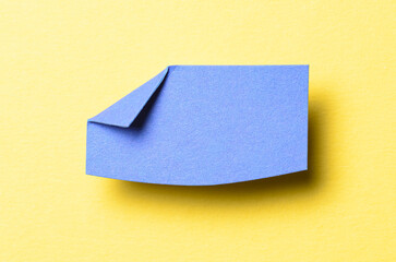 Blue blank paper note cardboard with folded corner dog-ear earmark, shadow and copy space for text...