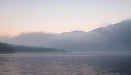 A serene view of a tranquil lake surrounded by majestic mountains, shrouded in a soft morning mist. The air is filled with a peaceful stillness.