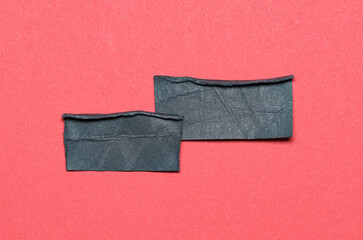 Two black overlapping torn ripped blank paper notes with folded edge dog-ear earmark and copy space...