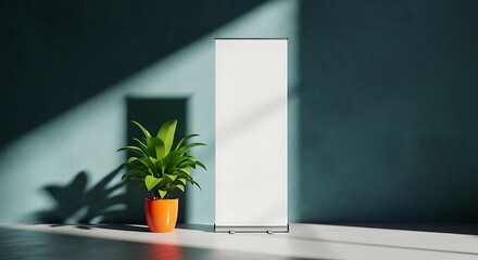 A blank roll up banner stand with a plant