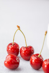 Cherries scattered on white for snack prep or bright food styling concept