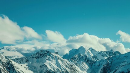 Obraz premium Scenery of the Blue Snow Mountain Range,panoramic view of the Alps—Towering Peaks in Azure Tones, Snow-Capped Summits & Vast Landscapes, Nature’s Breathtaking Alpine Canvas.