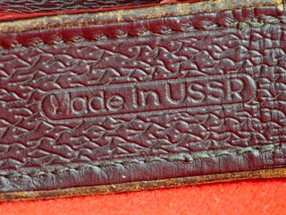 Inscription on a leather case of vintage opera glasses. Made in USSR. 1960s.
