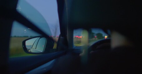 A nighttime drive on a highway reveals illuminated streetlights and city glows. The driver reflects on the world, feeling introspective and adventurous