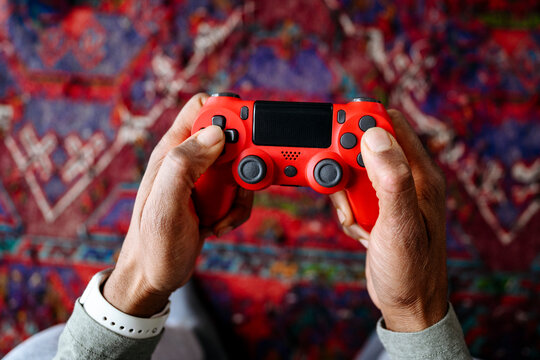 Hands of man holding gamepad