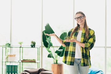 Young professional woman presenting concepts in a modern office interior setting showcasing style...
