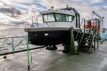 A Modern Tugboat has been successfully Docked at a Jetty with a Scenic Sunset Over the Water