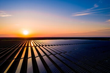 Aerial View: Vast Solar Farm at Sunset, Golden Hour, Renewable Energy, Sustainable Power Generation