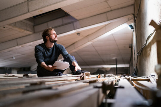 Actor rehearsing with script at theatre