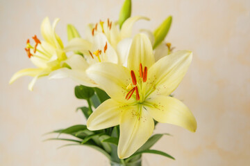 Fototapeta premium Yellow lilies in glass vase – perfect for natural home decor or minimalist floral stock themes