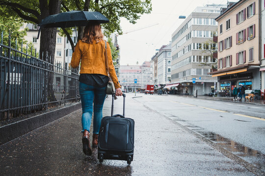 Young woman walking in the city on a rainy day, Zurich, Switzerland