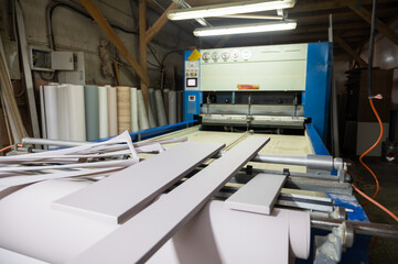 Grinding of wooden furniture panels on a machine. Furniture production concept