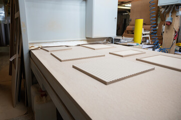 Grinding of wooden furniture panels on a machine. Furniture production concept