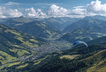 Naklejka premium Mountain valley vista with paraglider