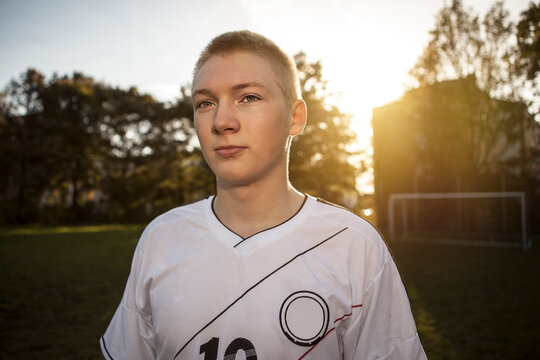 Confident teenager on soccer pitch