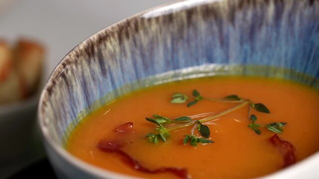 Bright yellow bowl filled with creamy shell pasta, garnished with fresh basil and grated cheese.
