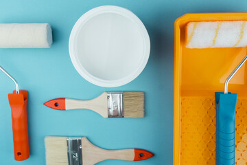 Set of painting tools on cyan background for DIY renovation and household improvement concept