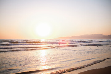 Gentle beach waves with pastel reflections and soft ocean light