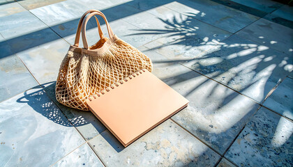 Summer flat lay on a concrete background Peach notepad and an eco-friendly mesh shopping bag
