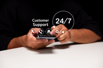 Person using a smartphone with digital icons representing 24/7 customer support services floating...