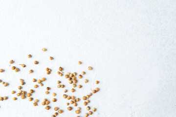 scattered coriander seeds on white background