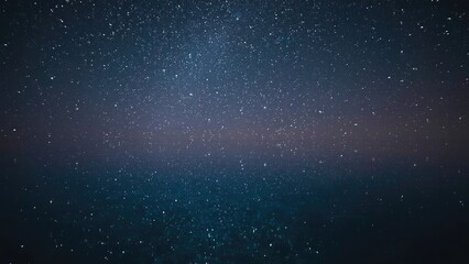 Obraz premium A calm, reflective lake mirroring a clear night sky filled with stars. The water is perfectly still