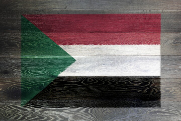 Sudan flag on rustic old wood surface background