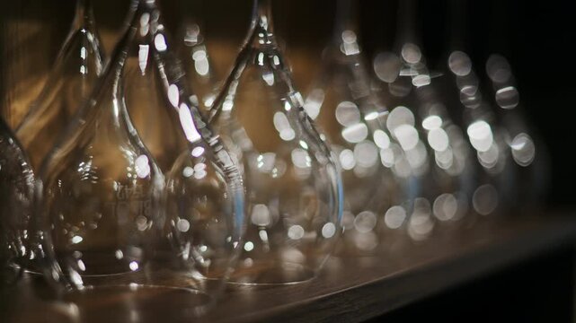 Close up of empty glasses turned upside down on a shelf