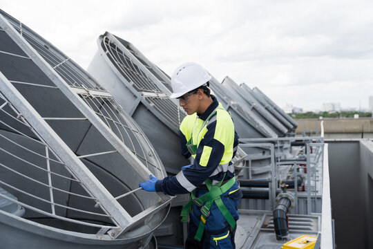 Engineer or technicians maintenance and repair of cooling towers for preventing issues Legionella growth on rooftop of building