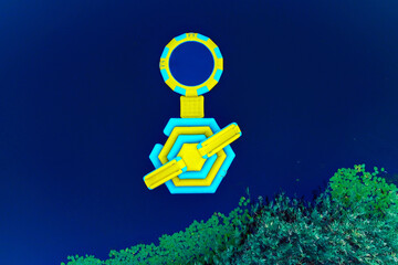 Aerial view of a yellow and blue floating platform resting on dark water near the green shoreline, Kherson, Kherson Oblast, Ukraine.