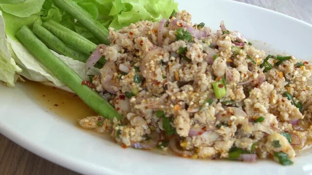 Close up of larb gai, a spicy thai chicken salad dish