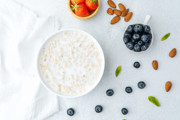 Oatmeal porridge with blueberries, strawberries, almonds and milk