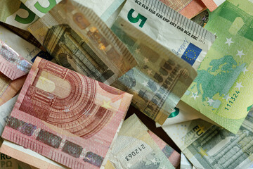 High-angle close-up shot of various euro banknotes, showcasing details and textures.