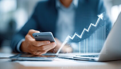 Business person using technology with growing graph overlay