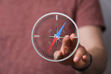Hand interacts with a virtual compass, showing direction and navigation. Perfect for travel,...