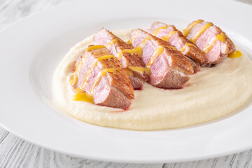 Sliced Duck Breast with Sauce and Thyme on Mashed Potato Bed