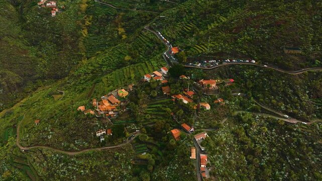 Aerial view of Masca village surrounded by dramatic cliffs and green terraces, Tenerife, Canary Islands