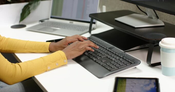 African American man placing hands on keyboard and typing updating data at desk, copy space