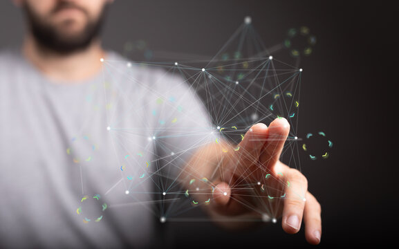 Close-up of a man's hand interacting with a digital network connection hologram.  Technology, innovation, future.