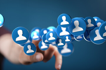 Abstract image of a hand reaching towards a network of social media profile icons.