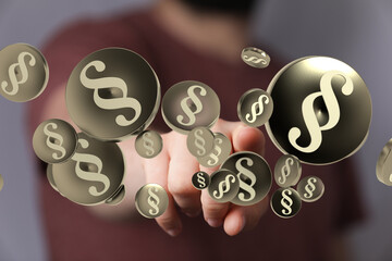 Abstract image of paragraph symbols floating towards a hand, representing legal concepts like law,...