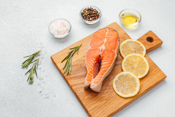 Preparing fresh salmon fillet with herbs and lemon for a healthy meal