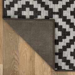 The specially designed carpet was laid on the floor and folded into a square format so that its...