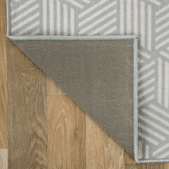 The specially designed carpet was laid on the floor and folded into a square format so that its...