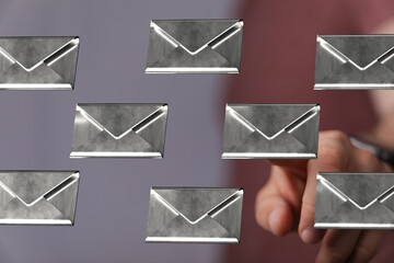 Person interacting with digital email envelopes, suggesting inbox management solutions.