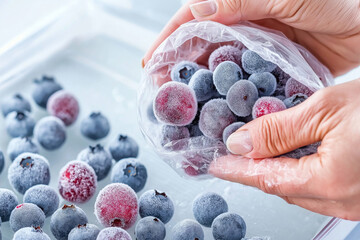 Frozen berries in plastic bag with frosted blueberries and cranberries