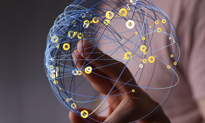 Abstract image of a hand interacting with a digital network sphere.  Concept of global connection...